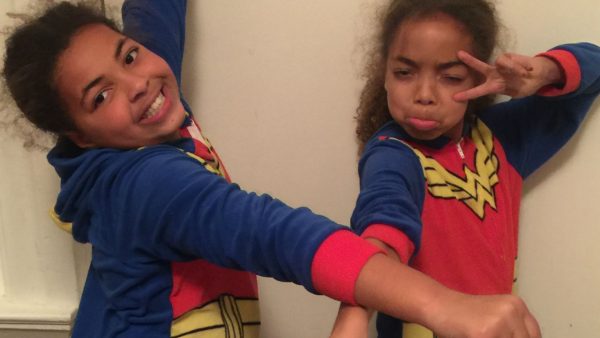 Nancy Netherland's two daughters with chronic illnesses wearing superhero pyjamas