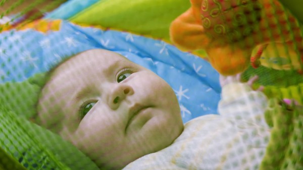 Baby lying in a playpen