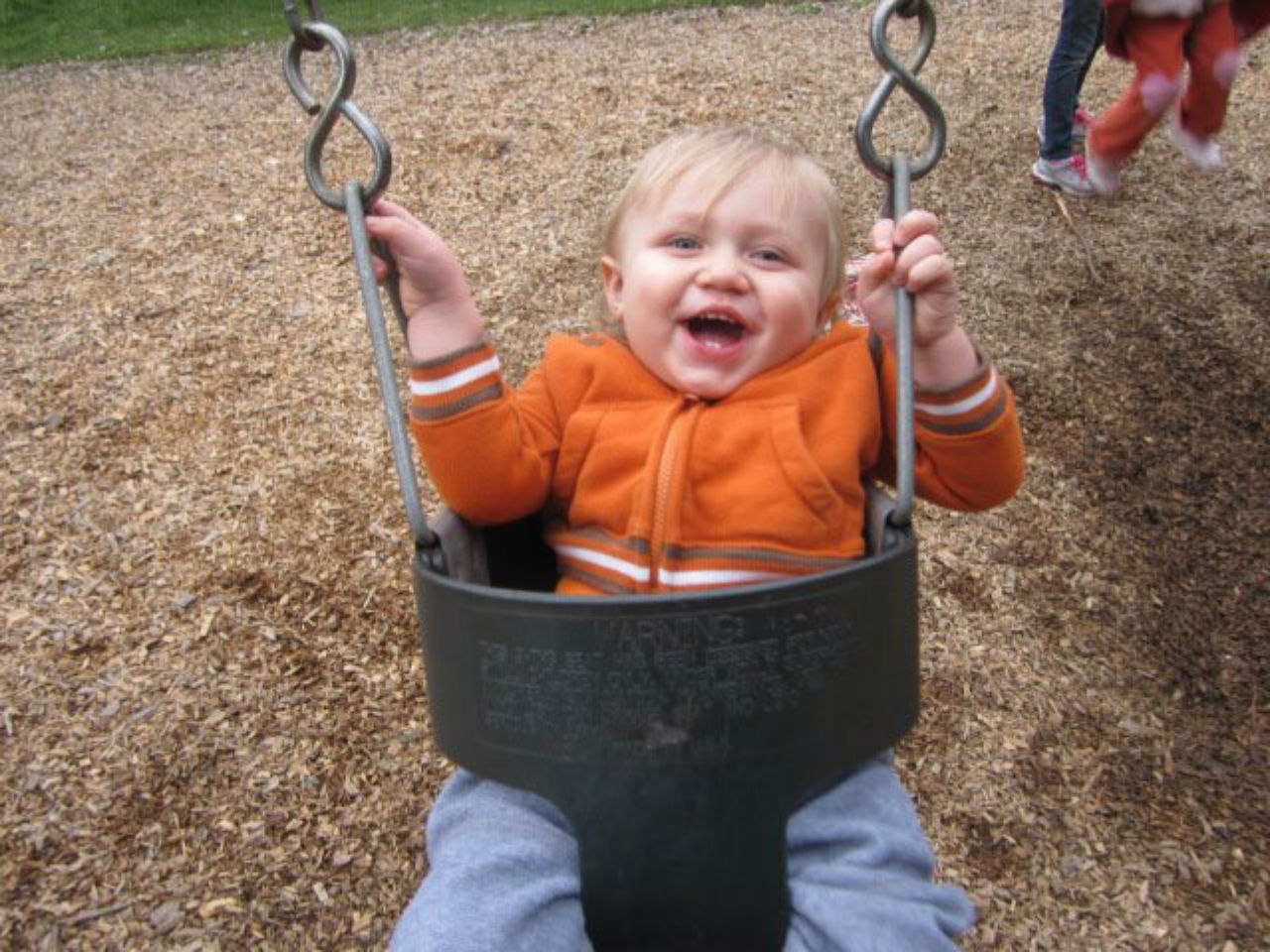 baby playing in swing
