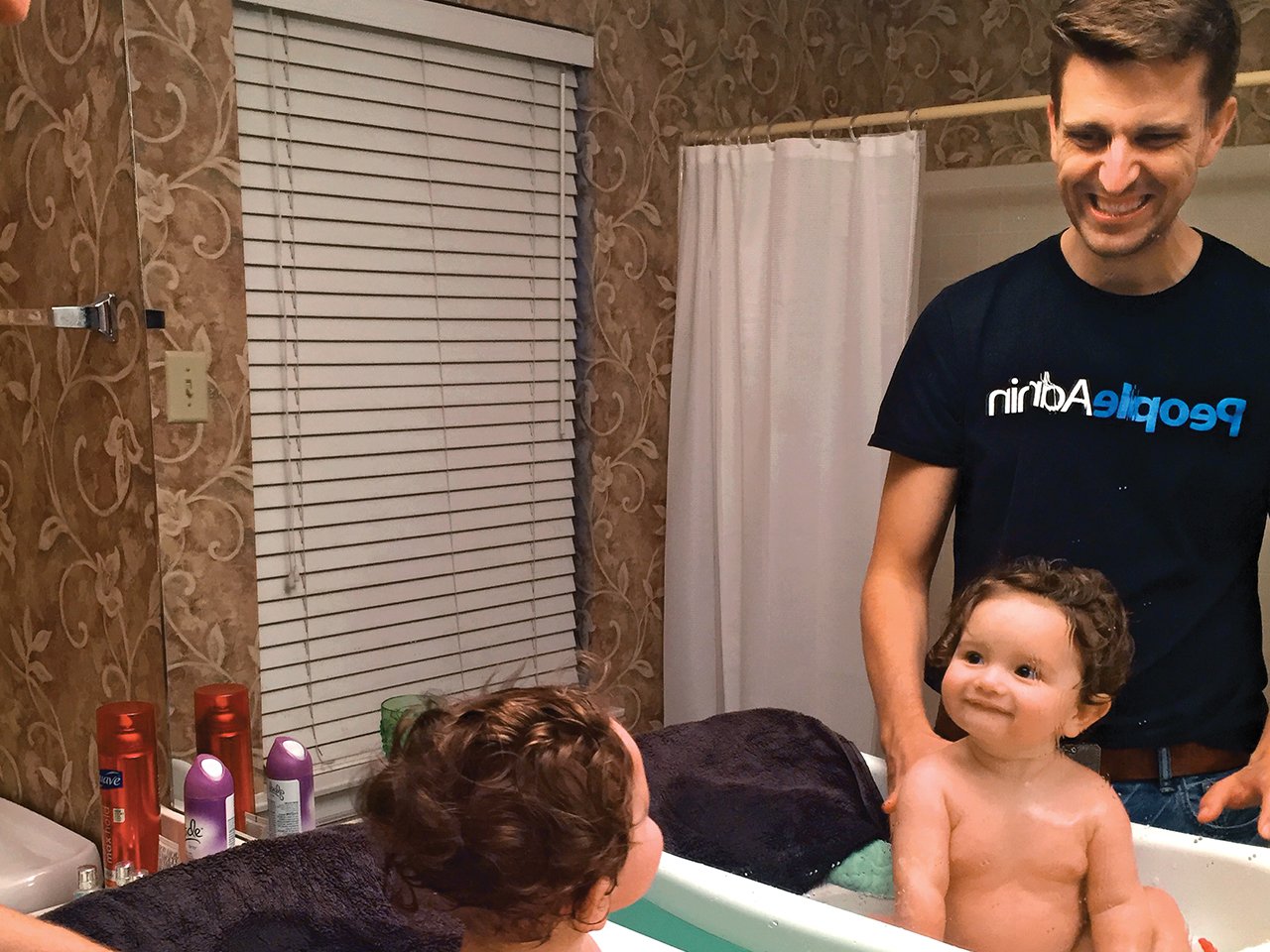 Dad and son are all smiles during a bath