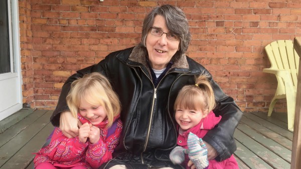 dad with two daughters on stoop