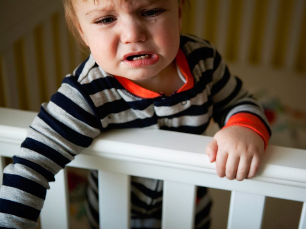 crying toddler in crib