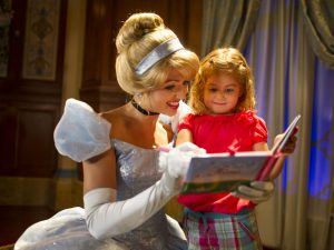 Cinderella and young girl reading a book