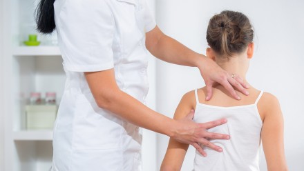 is chiropractic care safe for kids - Chiropractic Doctor Adjusts Elementary Girl