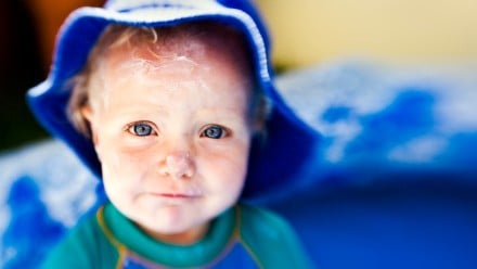 Baby with sunscreen on face