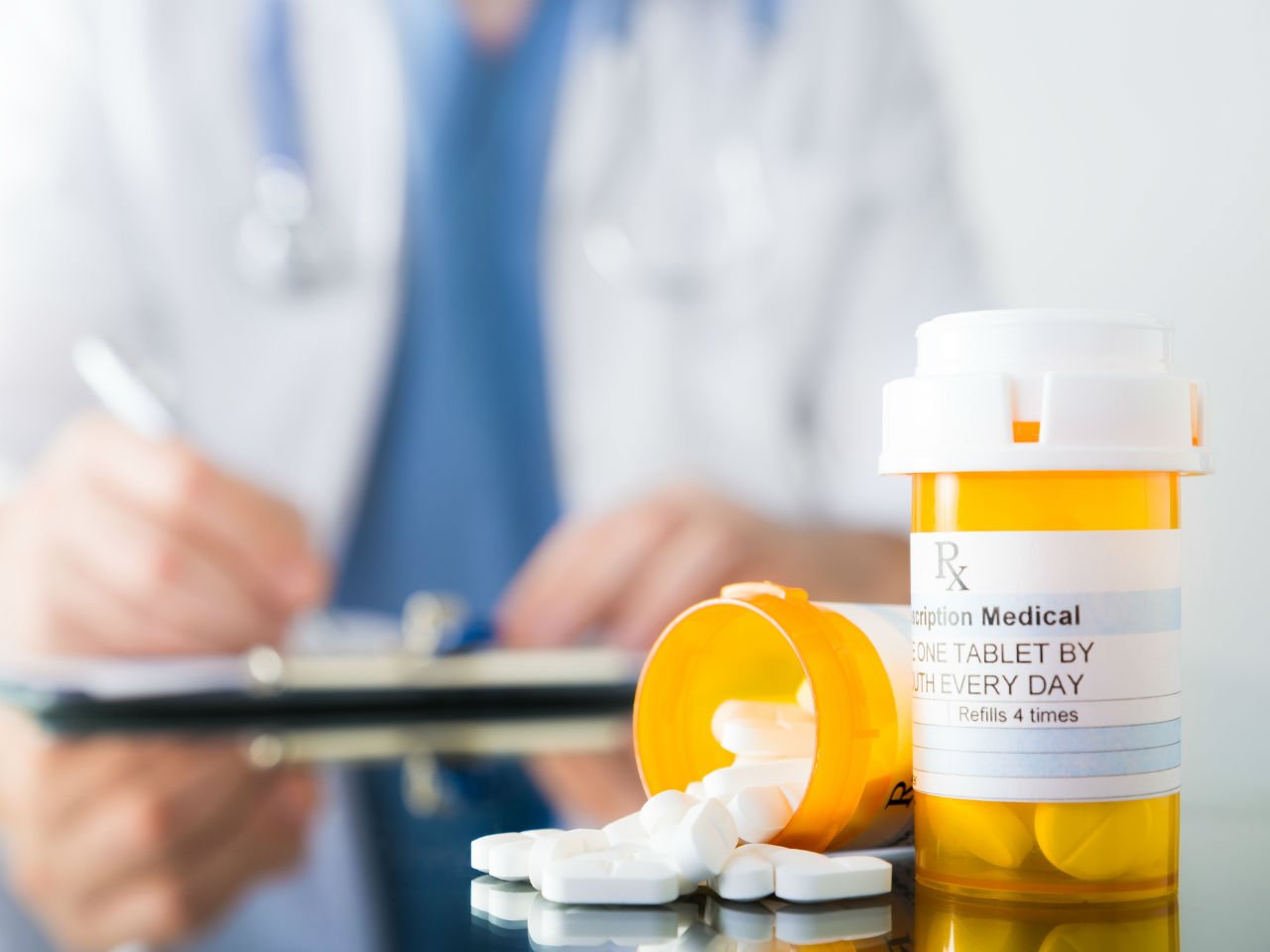 Doctor writing prescription for antibiotics