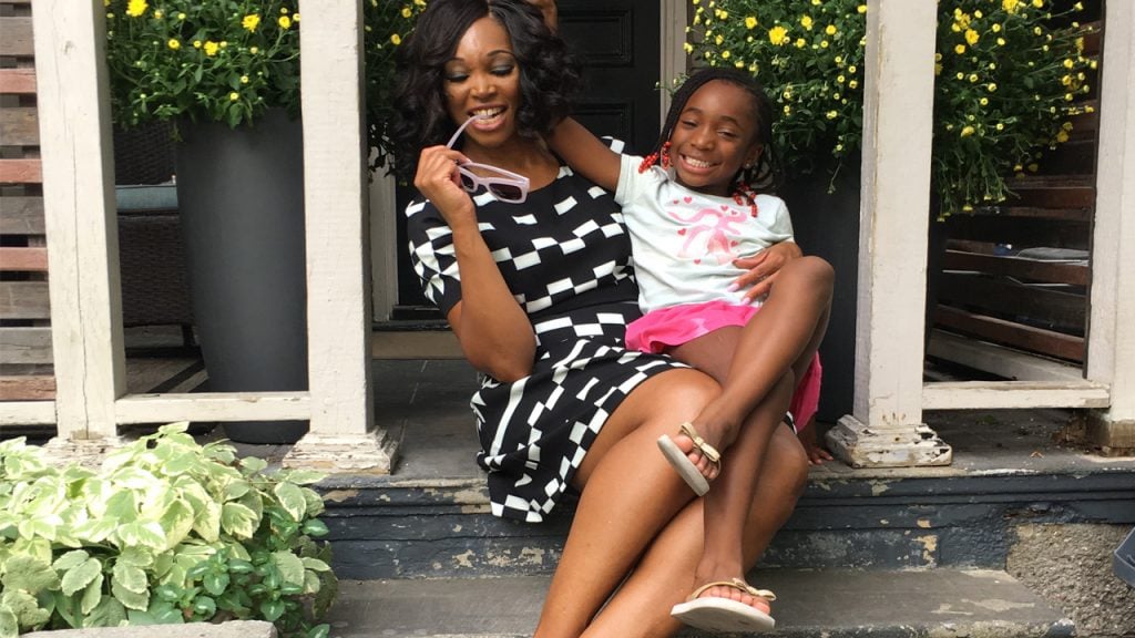 Tracy Moore and her daughter sitting on the front steps