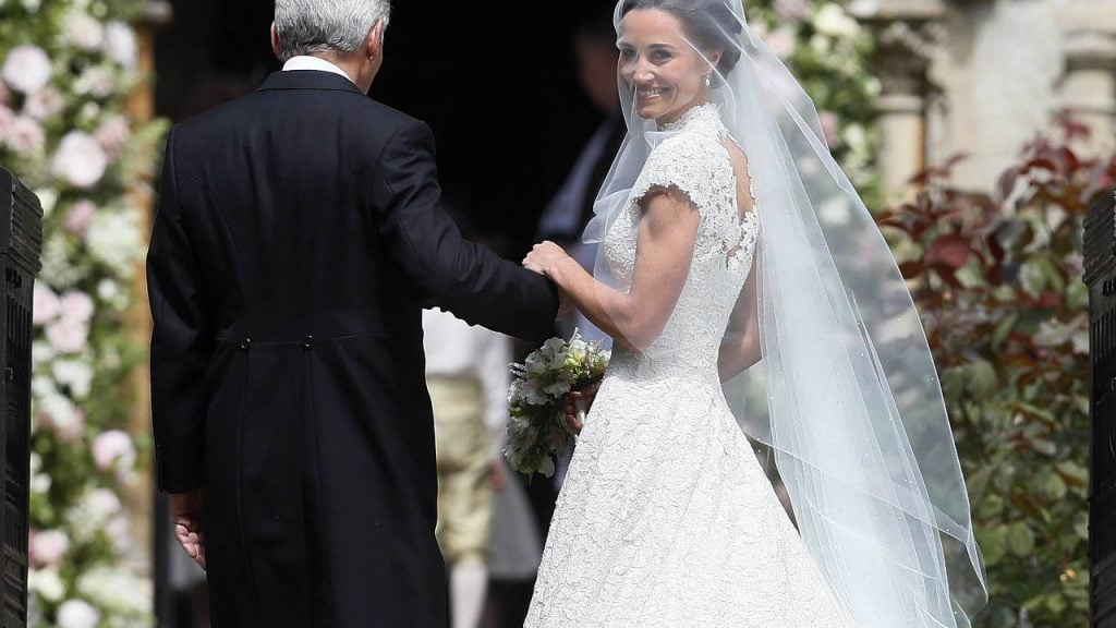 Pippa Middleton in her wedding dress being led into the church by her dad