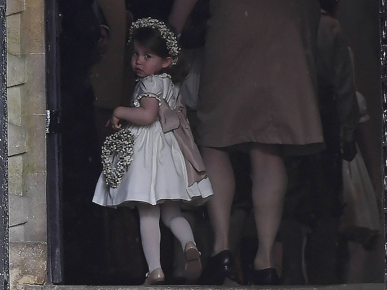 Princess Charlotte in a white dress entering a church