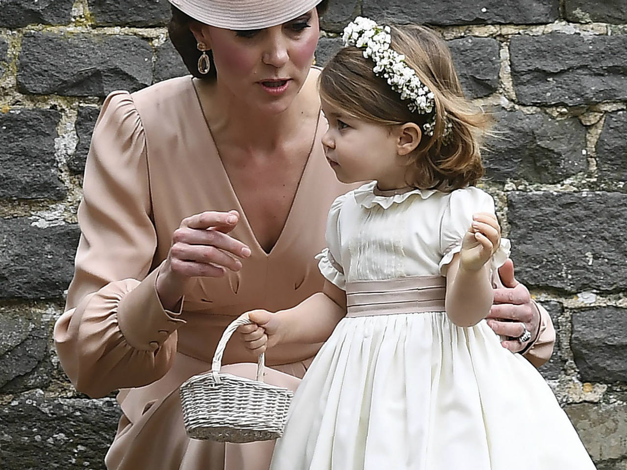Kate Middleton crouching down to talk to Princess Charlotte
