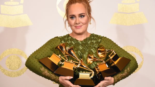 A picture of Adele holding all her Grammys