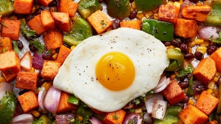 A sheet pan with vegetables and an egg on it