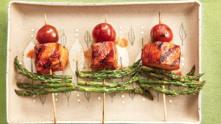 three skewers with chicken, asparagus and cherry tomatoes