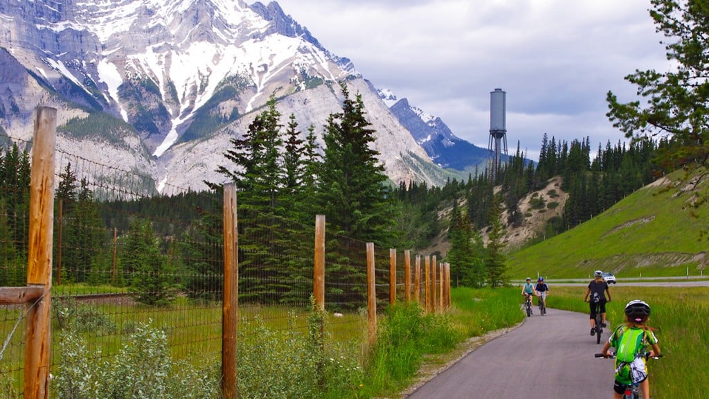 Family rides their bikes along the Legacy Trail in Canmore, AB