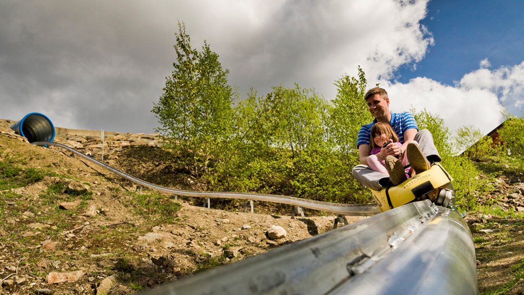 Dad and daughter ride down the Mountain Coaster at Revelstoke in BC