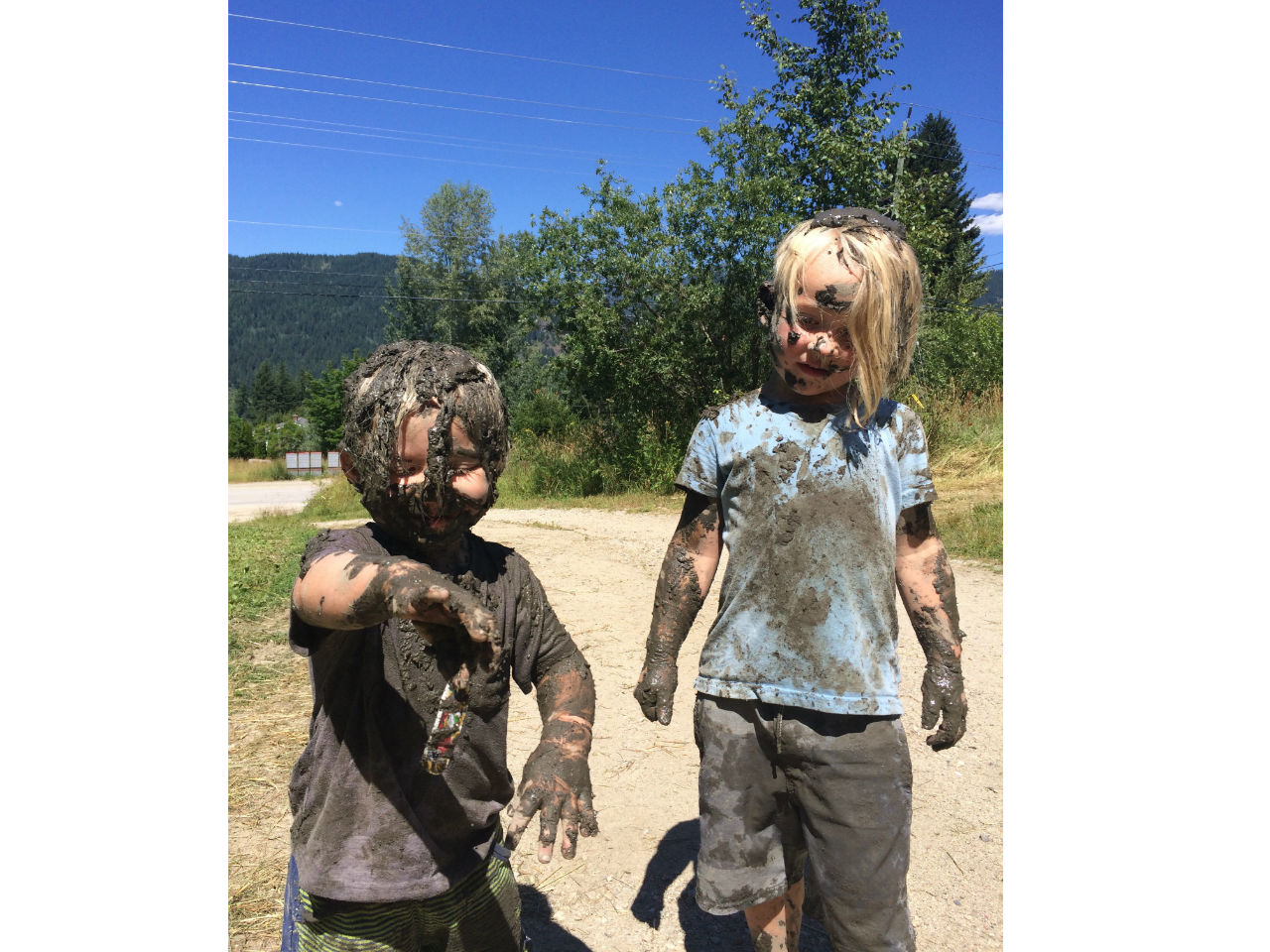 two brothers covered in mud