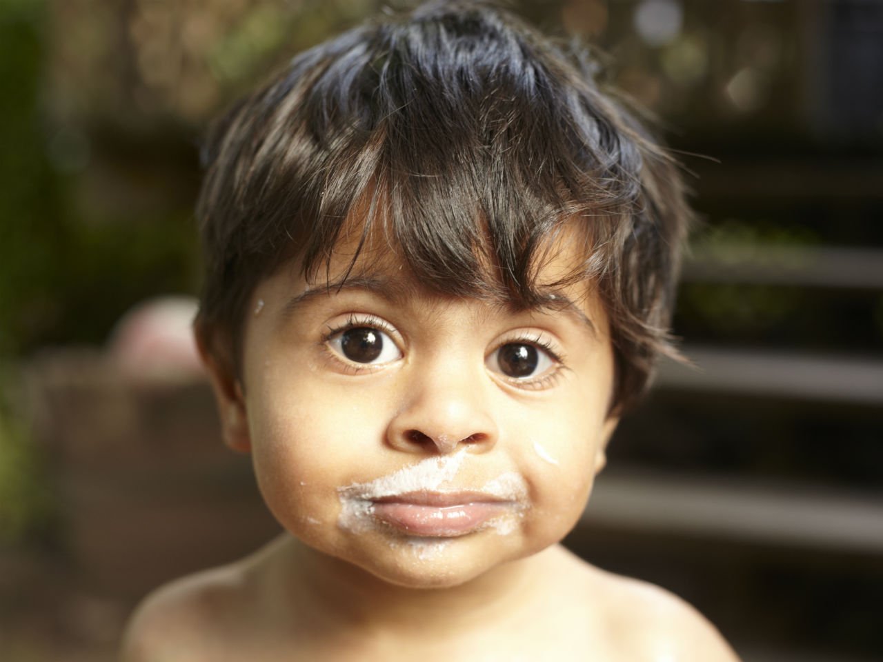 a little boy with ice cream on his face