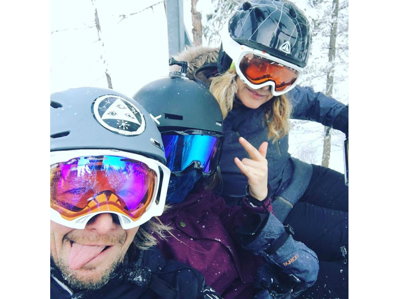 a family on a snowboard lift