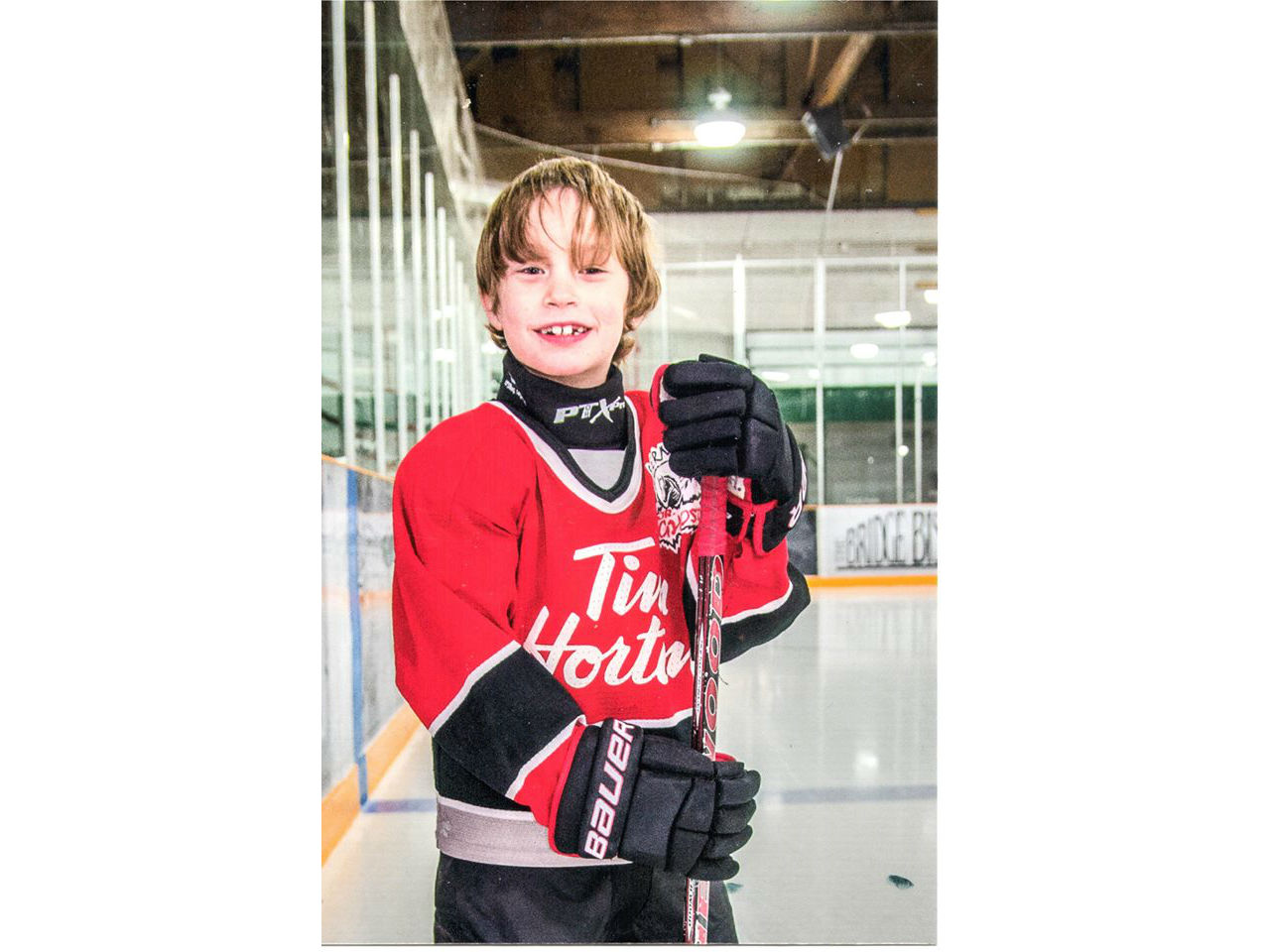 Ollie in a Tim Horton's hockey jersey on the ice