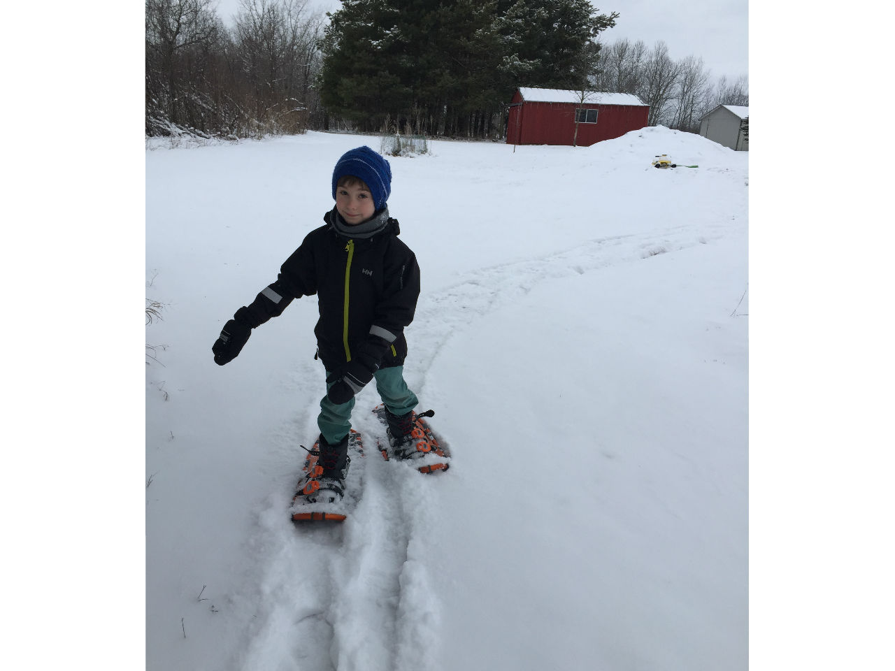 a boy snowshoing