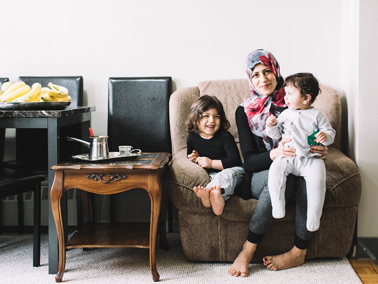 Ibtesam sits in her apartment with two of her seven children