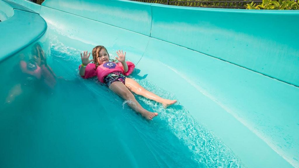 little girl slides down giant waterslide