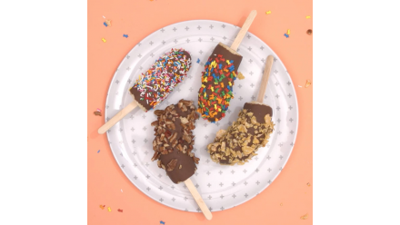 Bananas on sticks dipped in chocolate and fun toppings