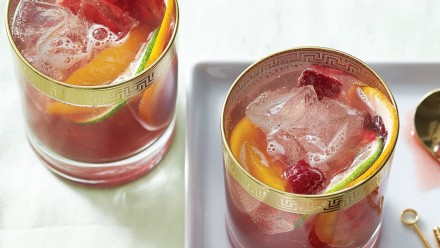 pink sangria cocktail in gold-trimmed cocktail glasses