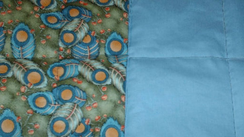 weighted blanket with pattern on one half and solid colour on the other