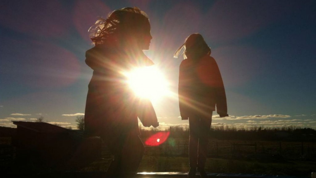 two little girls playing together at sunset