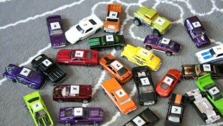 A bunch of tiny cars with letters on them