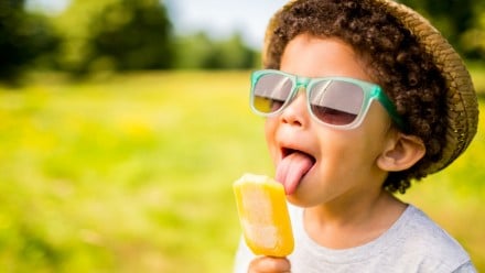 Little boy licking a Popsicle