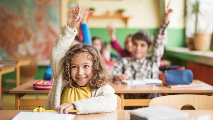 Girl with IEP raising hand in class