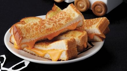 plate with grilled cheese sliced into thin strips