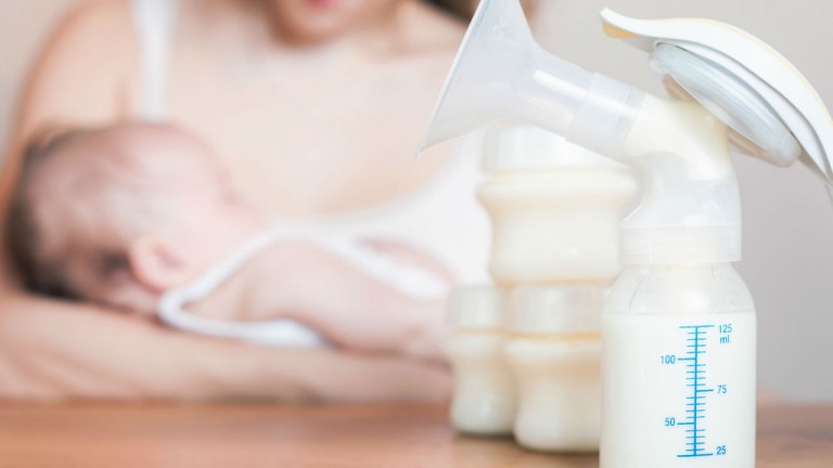 mother with baby breast pump on table
