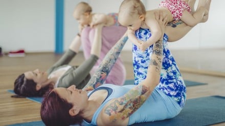 mommy and baby yoga class two moms pose with their babies