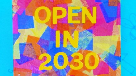 box decorated in colourful tissue paper squares that says "open in 2030"