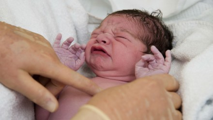 Newborn baby being cared for by a doctor