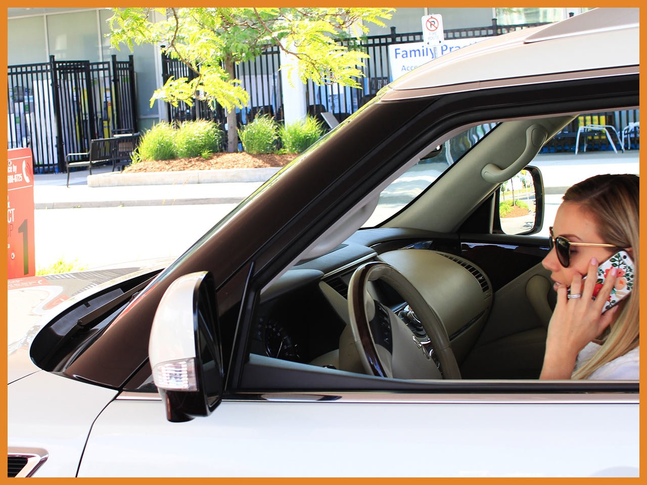 Joanna on the phone waiting in her car for her groceries to be delivered at the Loblaws Click & Collect pickup station