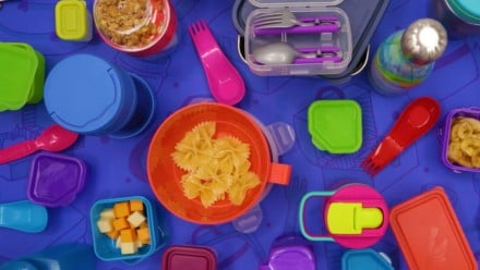 A bunch of school lunch accessories on a purple background