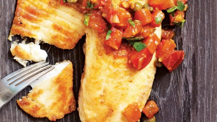 white fish with tomato and caper salsa on top