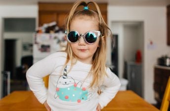 A young girl wearing sunglasses