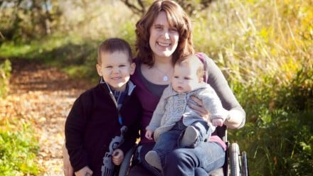 mother in wheelchair with her two children