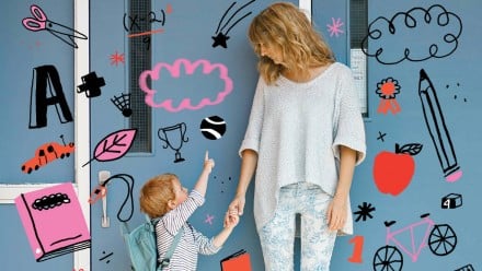 A blonde woman holding a young boy's hand