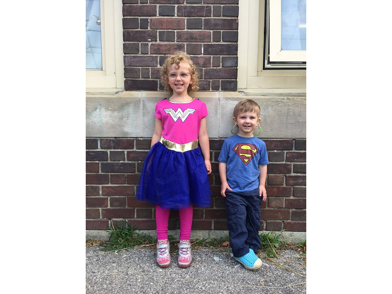 Brother and sister wearing a Wonder Woman and Superman t shirt