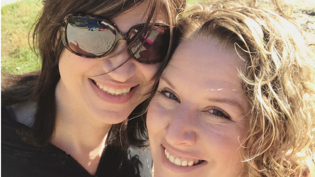 transgender woman and wife smiling for a personal photo together