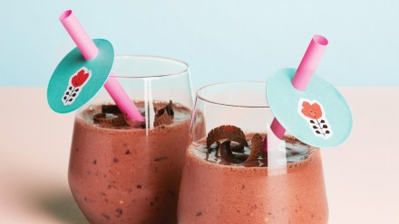 chocolate and cherry smoothie in glasses with colourful straws