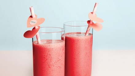 two tall glasses filled with pink smoothie