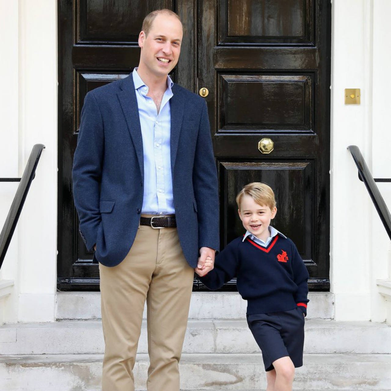 Prince George and Prince William smiling at the camera