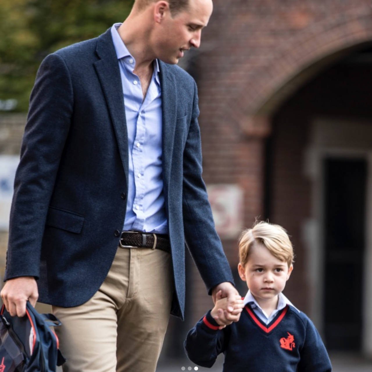 Prince William holding Prince George's hand
